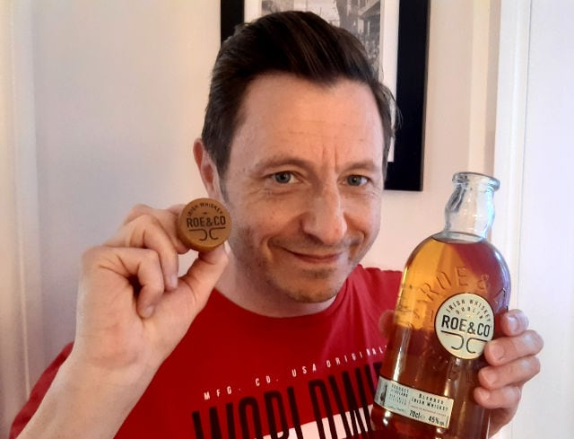 Andrew holding Roe & Co Blended Whiskey