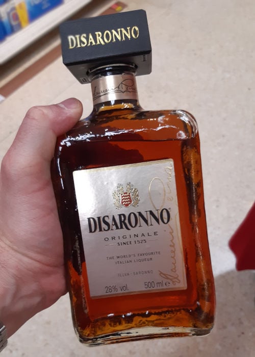 Ingrid holding a bottle of Disaronno Amaretto