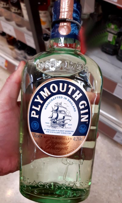 Ingrid holding a bottle of Plymouth Gin.